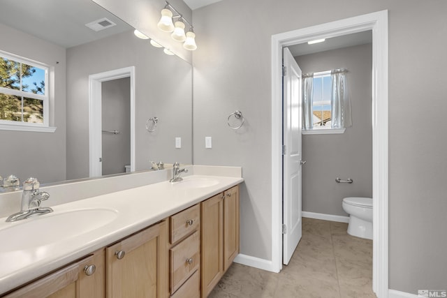 bathroom with tile patterned floors, vanity, and toilet