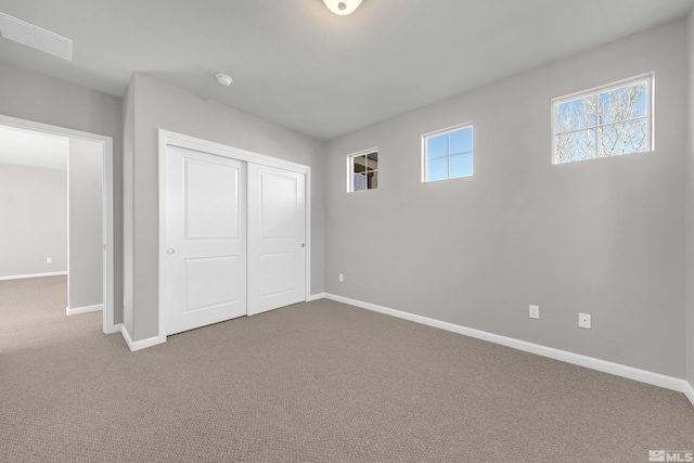 unfurnished bedroom featuring a closet and carpet flooring