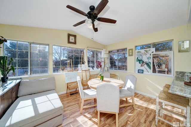 sunroom / solarium with lofted ceiling and ceiling fan