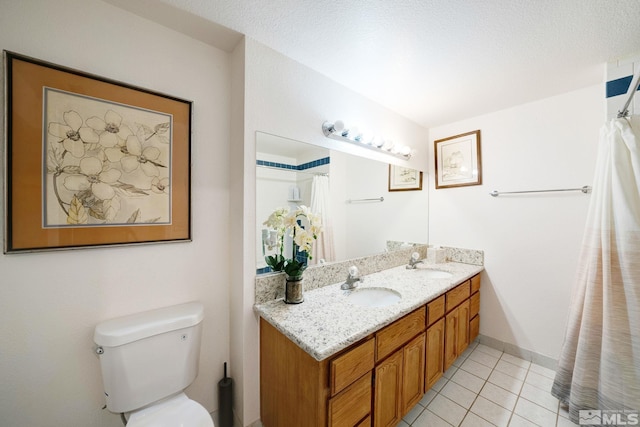 bathroom featuring tile patterned flooring, vanity, and toilet