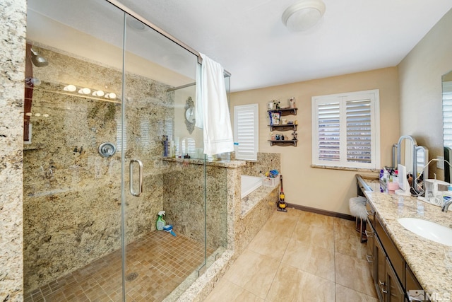 bathroom with tile patterned floors, vanity, and shower with separate bathtub