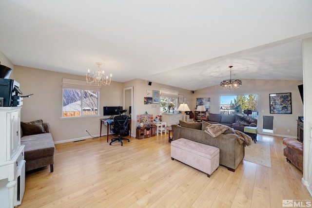 living room with light hardwood / wood-style flooring, an inviting chandelier, vaulted ceiling, and a wealth of natural light