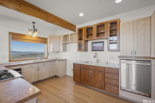 kitchen with pendant lighting, stainless steel appliances, light wood-type flooring, beamed ceiling, and sink