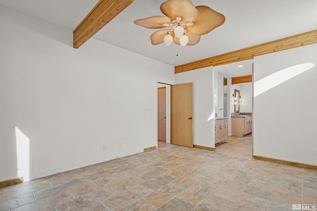 empty room featuring beam ceiling and ceiling fan