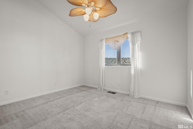 carpeted spare room featuring ceiling fan and lofted ceiling