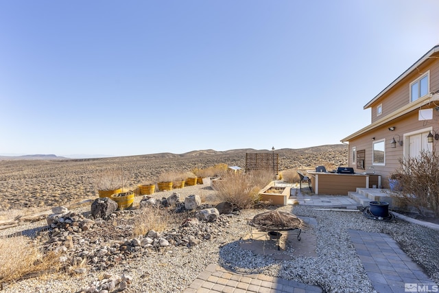 view of yard featuring a patio and a mountain view