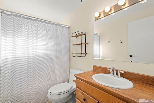 bathroom with toilet, walk in shower, and vanity