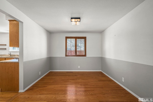 empty room with dark wood-type flooring and sink