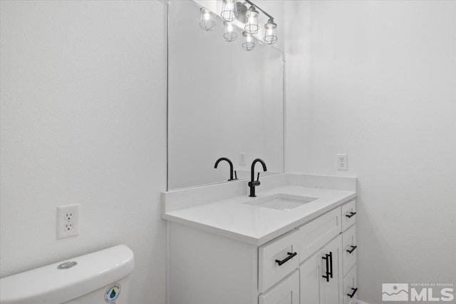 bathroom with toilet and vanity