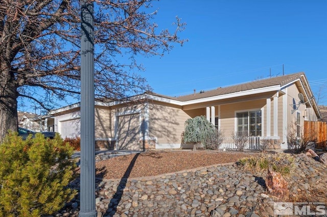 single story home with a porch and a garage