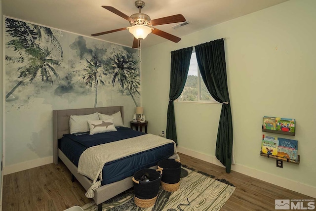 bedroom featuring ceiling fan and dark hardwood / wood-style floors