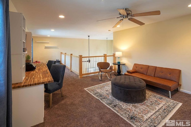 living room with ceiling fan and dark colored carpet