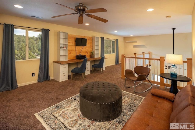 office area featuring ceiling fan and dark colored carpet