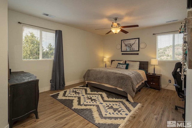 bedroom with wood-type flooring and ceiling fan