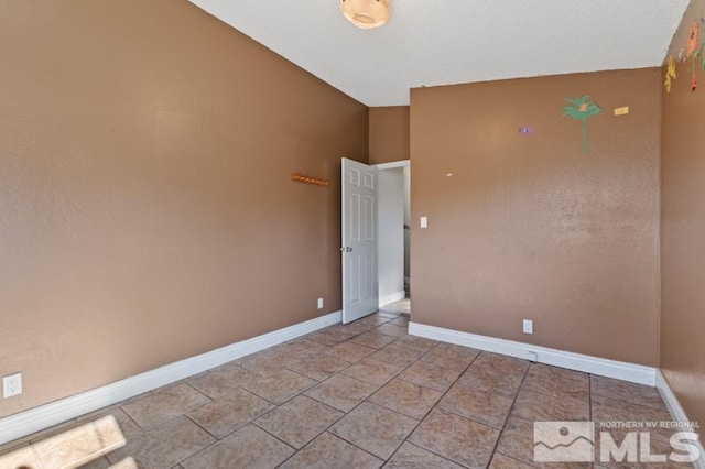 unfurnished room featuring light tile patterned flooring