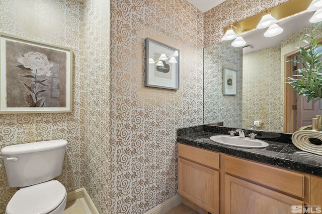 bathroom featuring toilet and vanity