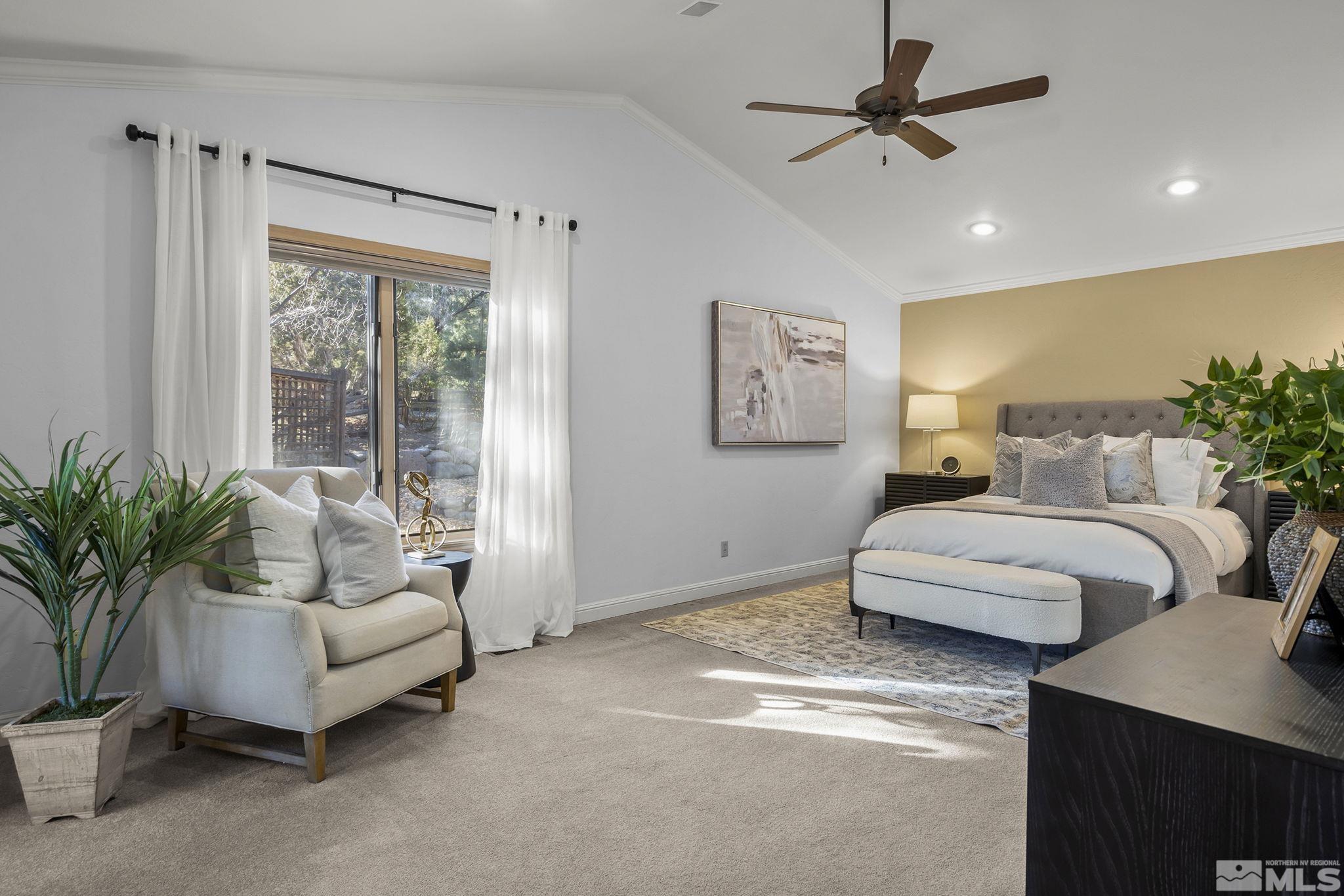 bedroom featuring vaulted ceiling, ornamental molding, ceiling fan, and carpet