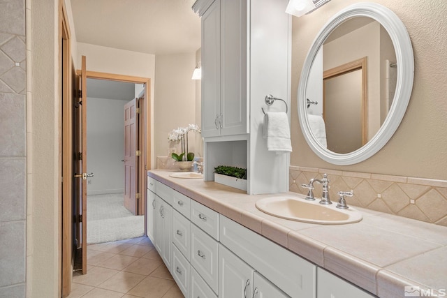 bathroom with tile patterned floors, backsplash, and vanity