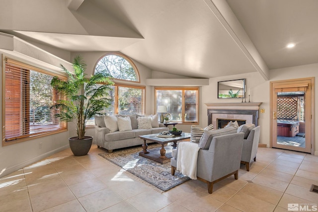 living room featuring lofted ceiling, light tile patterned flooring, a fireplace, and a healthy amount of sunlight