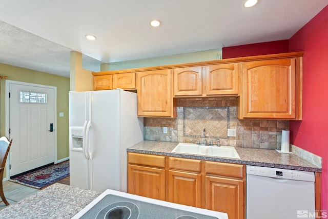 kitchen with sink, white appliances, and tasteful backsplash