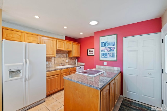 kitchen featuring white appliances, light stone countertops, light tile patterned floors, sink, and backsplash