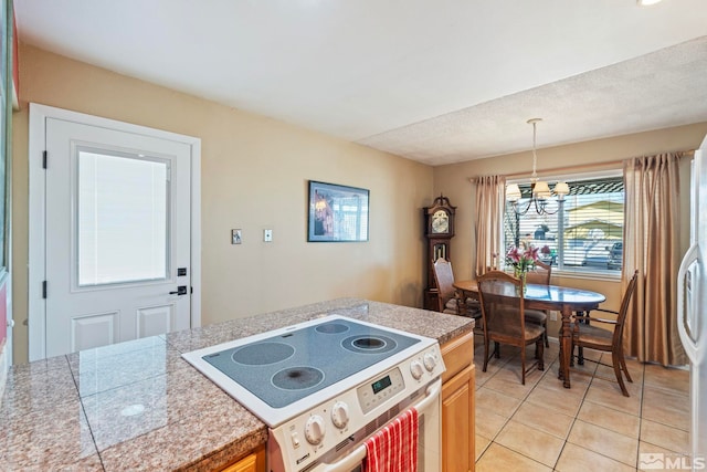 kitchen with a chandelier, hanging light fixtures, light tile patterned floors, and range with electric stovetop