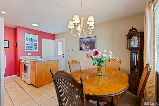 tiled dining space with a chandelier