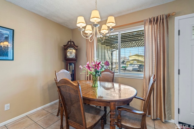 dining room featuring a textured ceiling, a notable chandelier, and light tile patterned floors