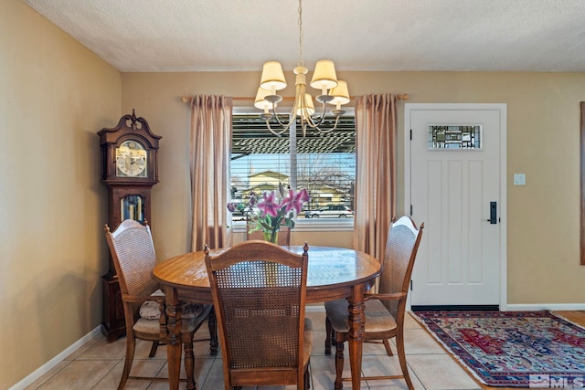 dining room featuring a textured ceiling, an inviting chandelier, and light tile patterned floors