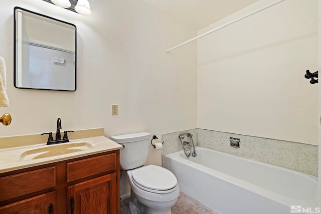 bathroom with tile patterned floors, toilet, vanity, and a bathing tub