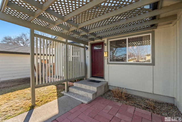 doorway to property with a pergola