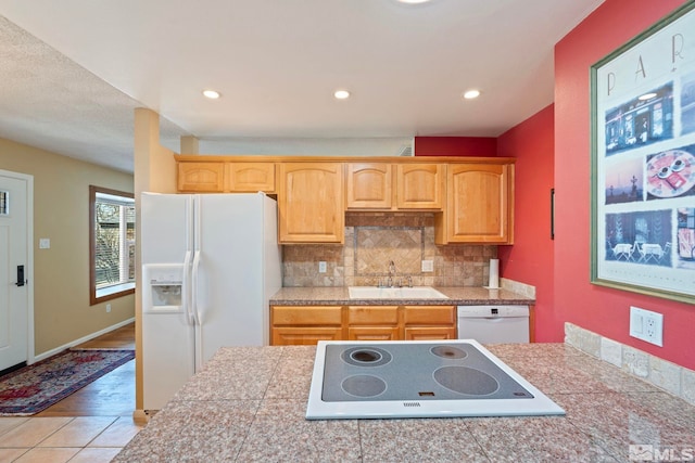 kitchen featuring white appliances, backsplash, sink, and light tile patterned floors