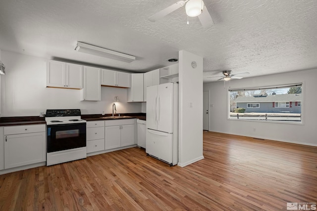 kitchen with white fridge, electric range, light hardwood / wood-style flooring, and white cabinetry