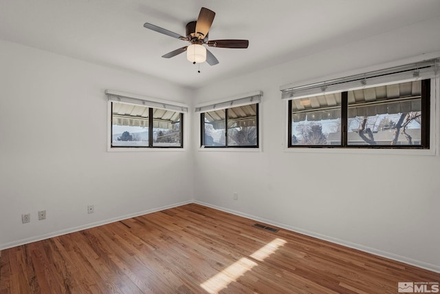 unfurnished room featuring hardwood / wood-style flooring and ceiling fan