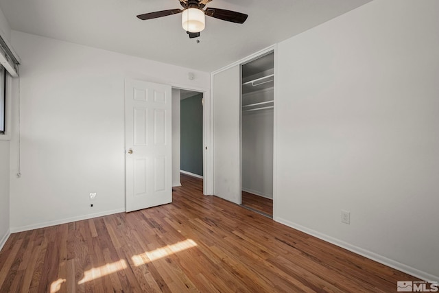 unfurnished bedroom featuring ceiling fan, hardwood / wood-style floors, and a closet