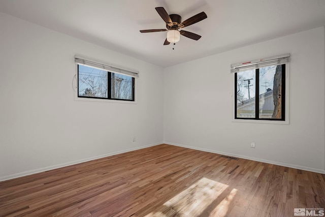 unfurnished room with ceiling fan, light hardwood / wood-style floors, and a wealth of natural light