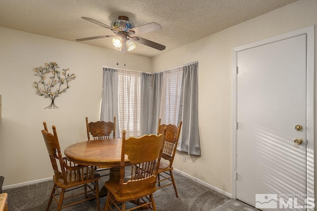 carpeted dining room featuring a textured ceiling and ceiling fan