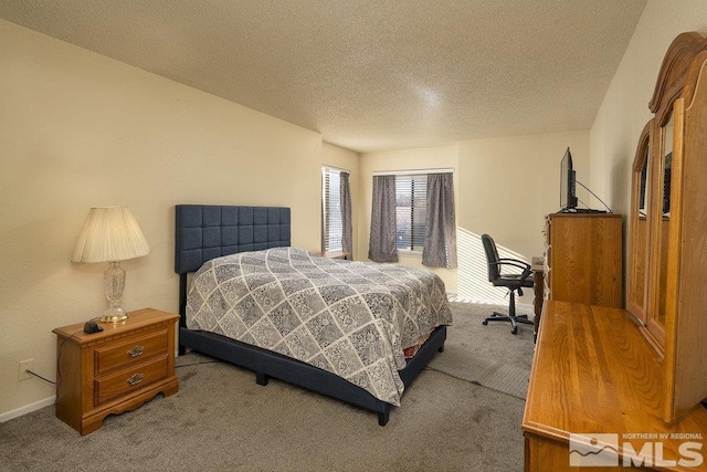 bedroom featuring a textured ceiling and carpet floors