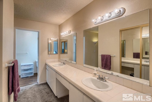 bathroom featuring vanity and a textured ceiling