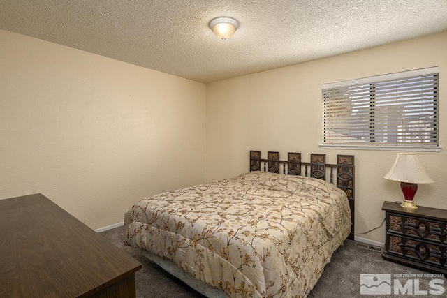 carpeted bedroom with a textured ceiling