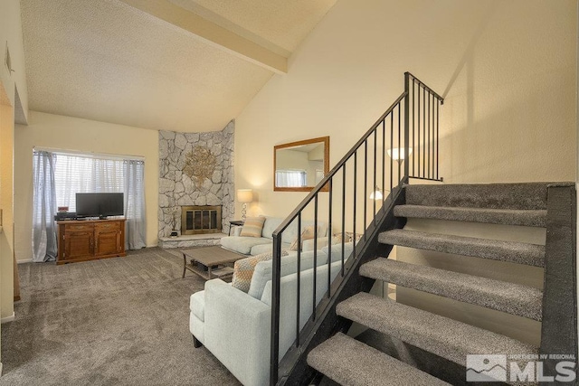 living room with a stone fireplace, beamed ceiling, high vaulted ceiling, carpet flooring, and a textured ceiling