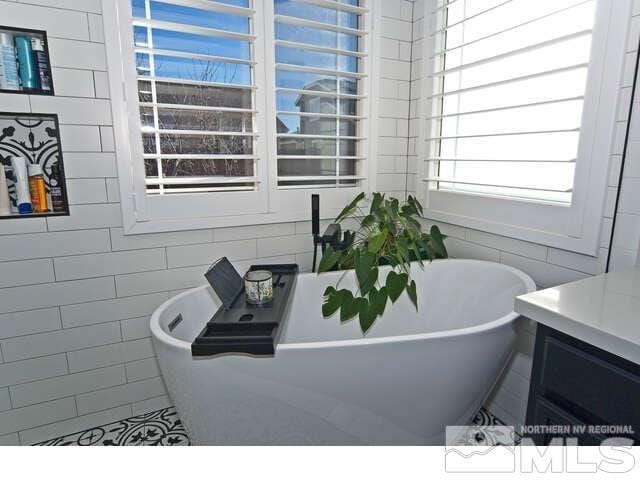 bathroom featuring vanity and a tub