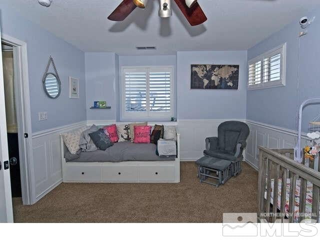 bedroom featuring ceiling fan and carpet