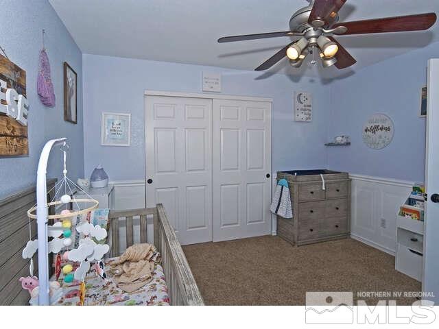 carpeted bedroom with a closet and ceiling fan