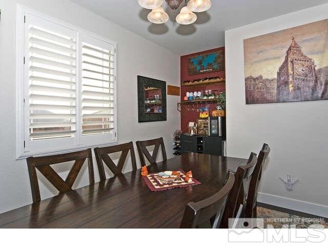 dining area with an inviting chandelier