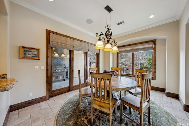 dining room with a notable chandelier and crown molding