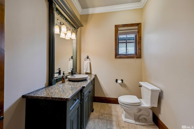 bathroom with ornamental molding, vanity, and toilet