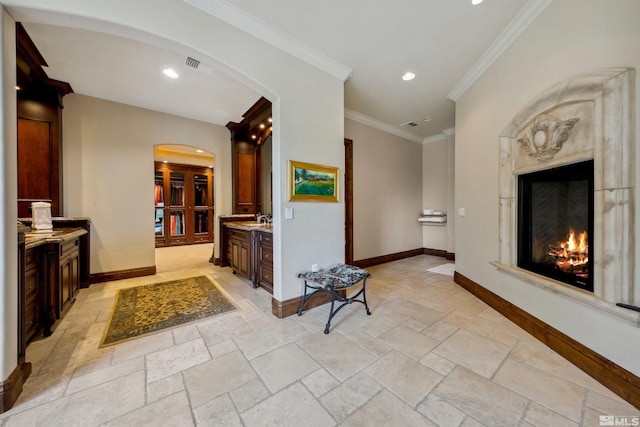 hall featuring sink and crown molding