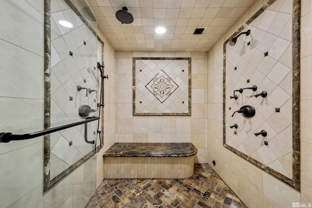 bathroom with tile walls and tiled shower