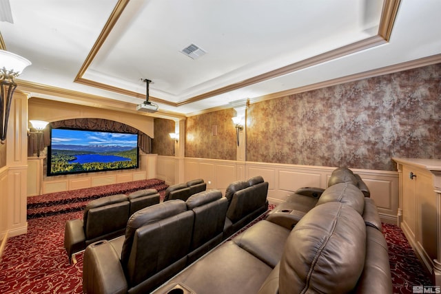 home theater with crown molding and a raised ceiling